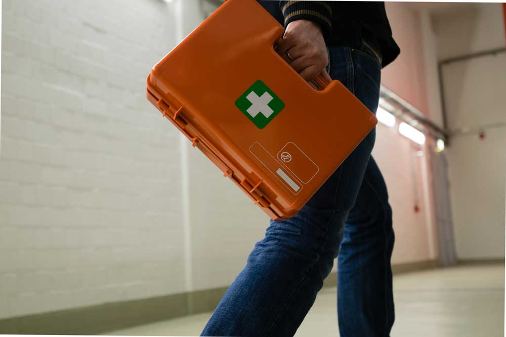 man walking with first aid kit. corporate security and EMT concept